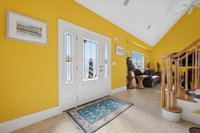 10 Delta Rd, Massapequa, NY 11758 - entryway featuring wood finished floors, baseboards, stairway, high vaulted ceiling, and a ceiling fan