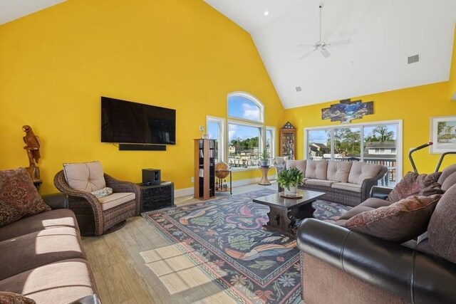 10 Delta Rd, Massapequa, NY 11758 - living room featuring high vaulted ceiling, hardwood / wood-style flooring, a ceiling fan, and baseboards