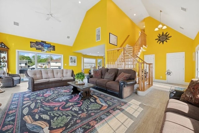 10 Delta Rd, Massapequa, NY 11758 - living room with high vaulted ceiling, wood-type flooring, stairway, ceiling fan, and baseboards