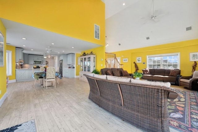 10 Delta Rd, Massapequa, NY 11758 - living room featuring ceiling fan, high vaulted ceiling, light wood finished floors, stairs, and recessed lighting