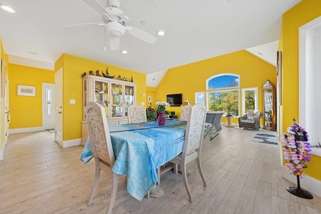 10 Delta Rd, Massapequa, NY 11758 - dining area featuring light wood finished floors, vaulted ceiling, healthy amount of natural light, baseboards, and a ceiling fan