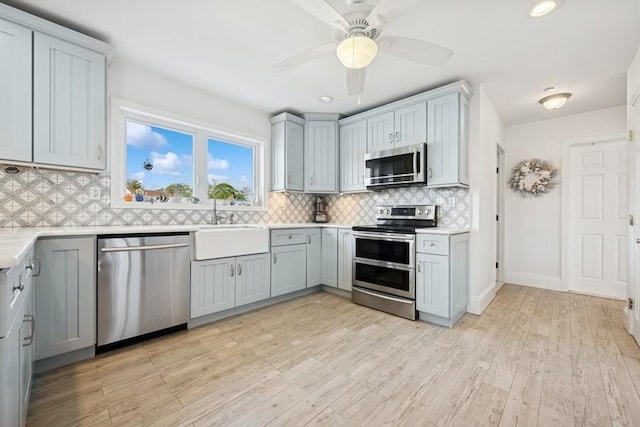 10 Delta Rd, Massapequa, NY 11758 - kitchen featuring stainless steel appliances, light countertops, tasteful backsplash, a ceiling fan, and recessed lighting