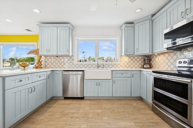 10 Delta Rd, Massapequa, NY 11758 - kitchen with appliances with stainless steel finishes, a sink, light countertops, healthy amount of natural light, and recessed lighting