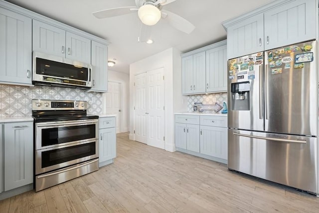 10 Delta Rd, Massapequa, NY 11758 - kitchen with stainless steel appliances, light countertops, decorative backsplash, ceiling fan, and recessed lighting
