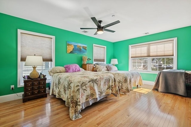 10 Delta Rd, Massapequa, NY 11758 - bedroom with hardwood / wood-style flooring, baseboards, and a ceiling fan