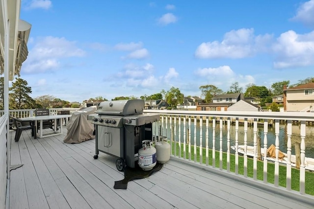 10 Delta Rd, Massapequa, NY 11758 - wooden deck with a water view, area for grilling, a lawn, outdoor dining area, and a residential view
