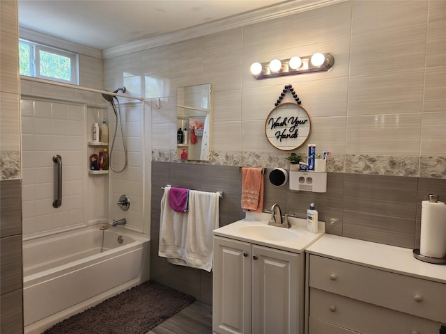 full bathroom featuring ornamental molding, vanity, and  shower combination