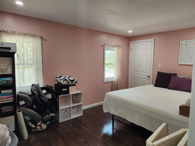 bedroom with recessed lighting, wood finished floors, and baseboards
