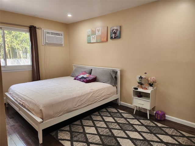 bedroom with baseboards, wood finished floors, and recessed lighting