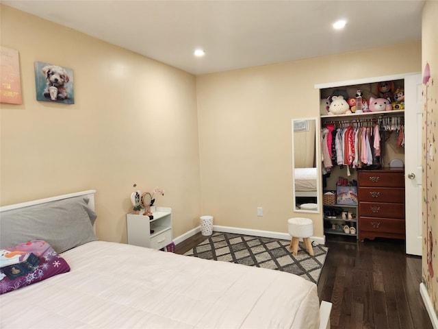 bedroom with recessed lighting, wood finished floors, a closet, and baseboards