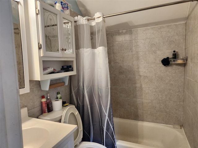 full bath with toilet, vanity, shower / bath combo with shower curtain, and tile walls