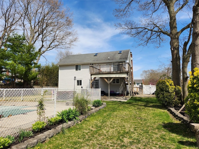 back of property with a fenced backyard, a yard, a patio, a wooden deck, and stairs