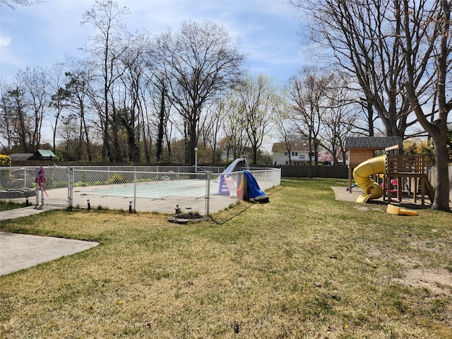 view of yard with a fenced in pool, fence, and playground community