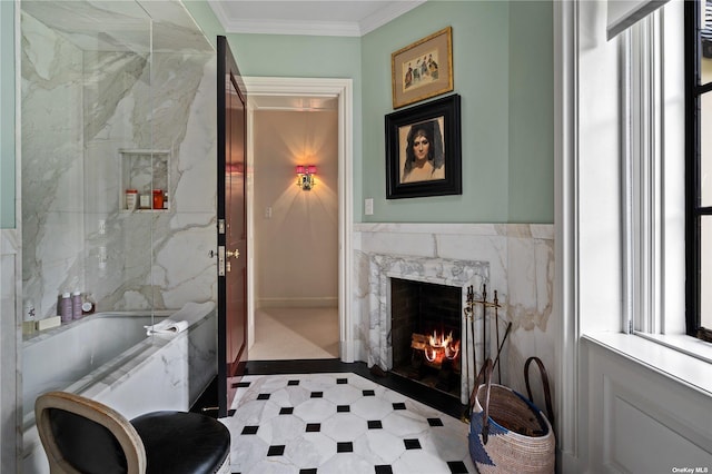 full bathroom featuring crown molding, tile walls, a fireplace, a bathing tub, and baseboards