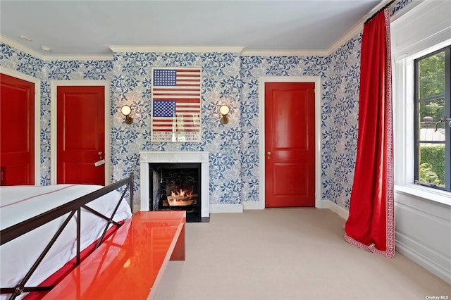 unfurnished room with crown molding, a fireplace with flush hearth, and carpet floors