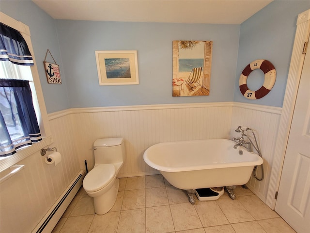 full bathroom featuring a soaking tub, toilet, baseboard heating, and wainscoting