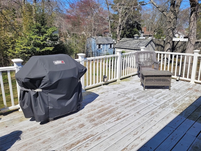 wooden terrace featuring a grill
