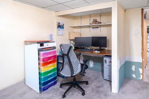 office area featuring carpet and a paneled ceiling