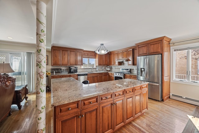 154-60 Riverside Dr, Whitestone, NY 11357 - kitchen featuring a baseboard heating unit, light wood-type flooring, light stone countertops, brown cabinetry, and appliances with stainless steel finishes