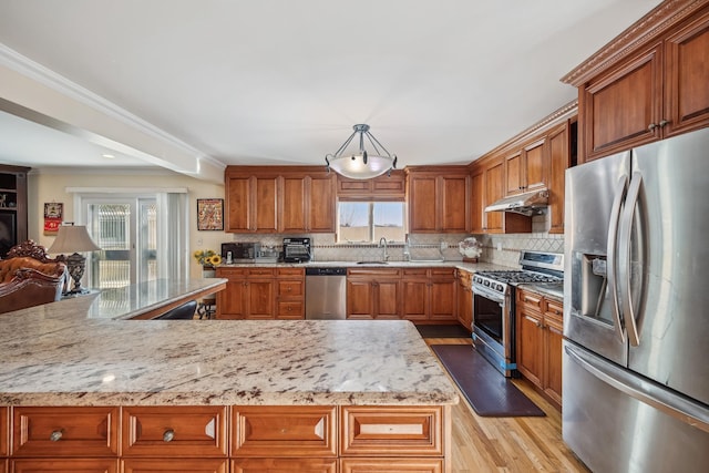154-60 Riverside Dr, Whitestone, NY 11357 - kitchen featuring a sink, brown cabinetry, light wood-style floors, appliances with stainless steel finishes, and under cabinet range hood