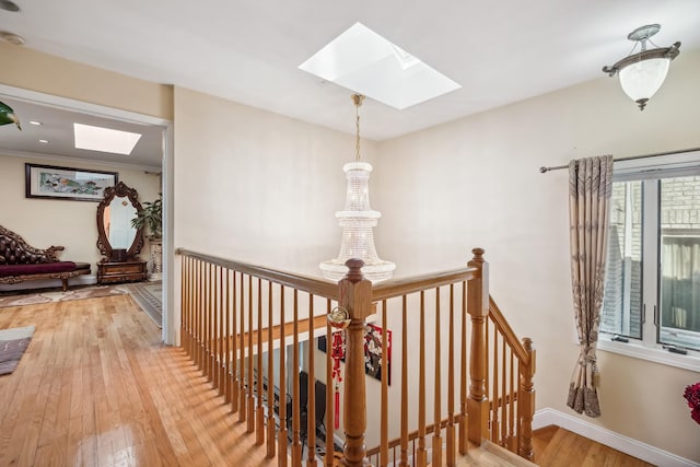 154-60 Riverside Dr, Whitestone, NY 11357 - corridor featuring a skylight, hardwood / wood-style flooring, baseboards, and an upstairs landing