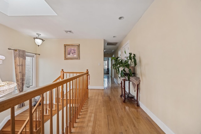 154-60 Riverside Dr, Whitestone, NY 11357 - corridor featuring light wood-type flooring, visible vents, baseboards, and an upstairs landing