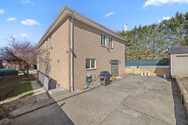 154-60 Riverside Dr, Whitestone, NY 11357 - view of side of property featuring brick siding, fence, and a patio