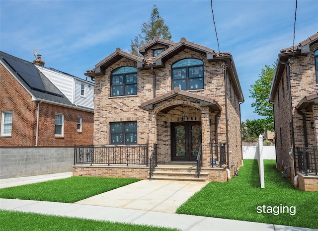 3405 Corporal Kennedy St, Bayside, NY 11361 - view of front of property with brick siding, a front lawn, and french doors