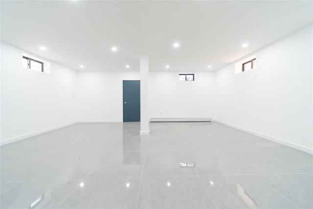 3405 Corporal Kennedy St, Bayside, NY 11361 - basement featuring recessed lighting, a baseboard heating unit, light tile patterned flooring, and a healthy amount of sunlight