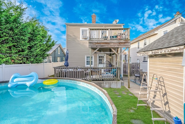 view of pool featuring a patio area, a deck, a fenced backyard, a yard, and a fenced in pool
