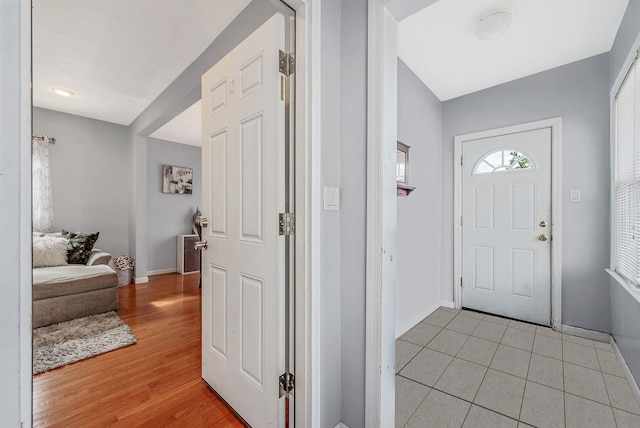 entrance foyer with light wood finished floors and baseboards