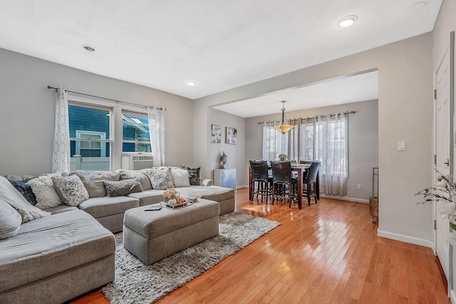 living room with light wood finished floors, plenty of natural light, baseboards, and recessed lighting