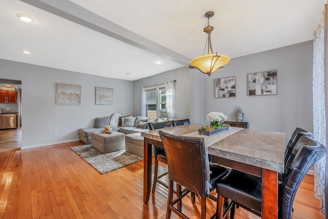 dining space featuring light wood finished floors, baseboards, and recessed lighting