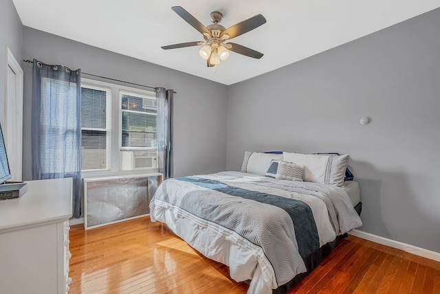 bedroom with baseboards, light wood-style floors, and ceiling fan
