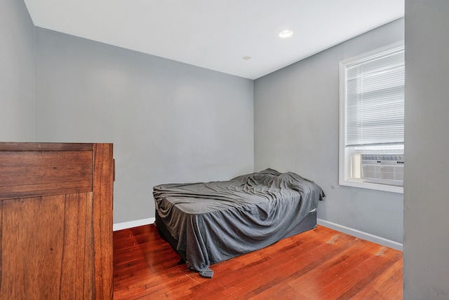 bedroom featuring wood finished floors and baseboards