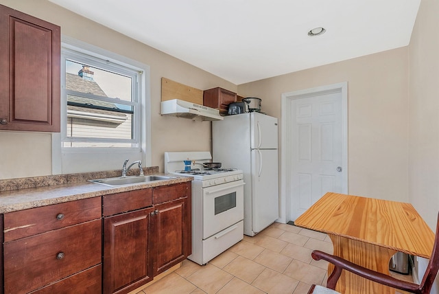 kitchen featuring a sink, light tile patterned flooring, white appliances, light countertops, and under cabinet range hood