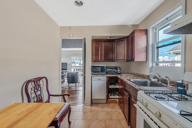 kitchen featuring a healthy amount of sunlight, a toaster, a sink, and white appliances