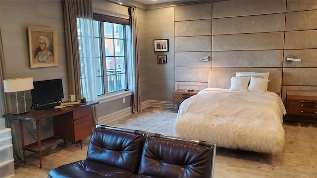 bedroom featuring multiple windows, baseboards, crown molding, and an office area