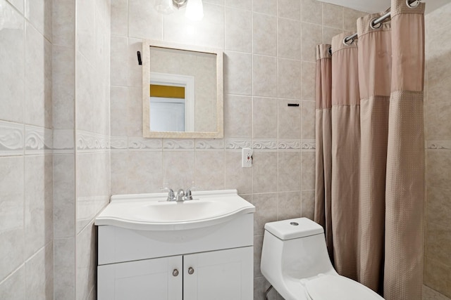 bathroom with curtained shower, tile walls, toilet, and vanity