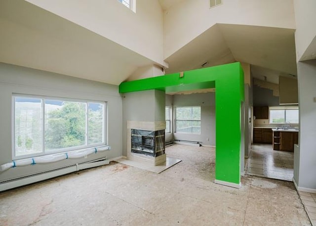 7 Cornwell St, Poughquag, NY 12570 - unfurnished living room with healthy amount of natural light, a baseboard radiator, a multi sided fireplace, high vaulted ceiling, and baseboard heating