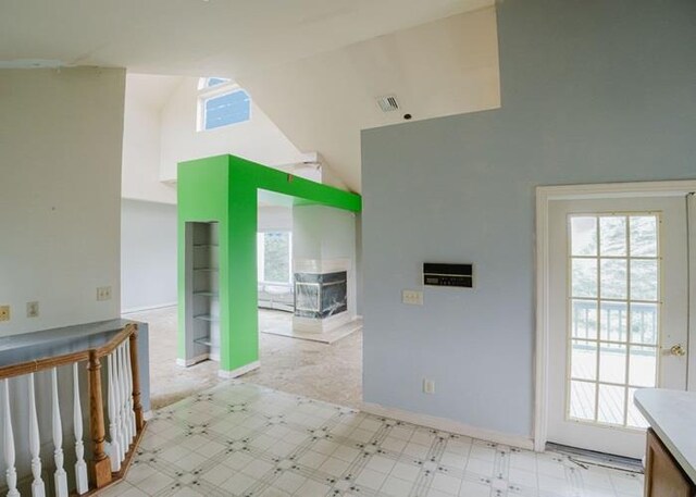 7 Cornwell St, Poughquag, NY 12570 - kitchen with high vaulted ceiling, plenty of natural light, a fireplace, and light floors