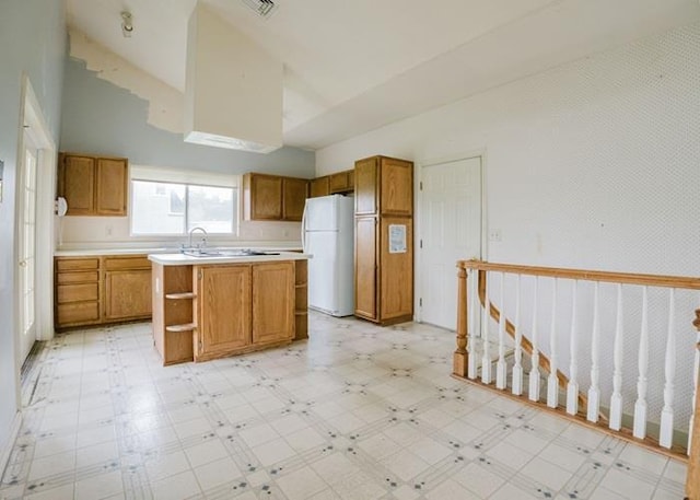 7 Cornwell St, Poughquag, NY 12570 - kitchen with freestanding refrigerator, light floors, high vaulted ceiling, brown cabinets, and light countertops