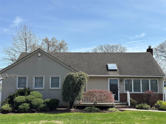 single story home with a front yard, a shingled roof, and a chimney