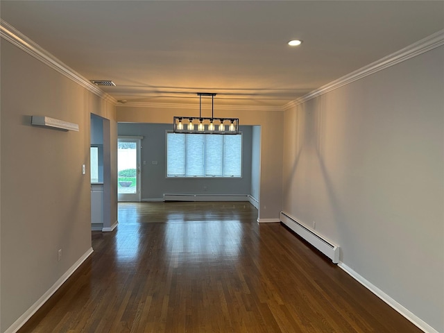 empty room with dark wood finished floors, visible vents, baseboard heating, and ornamental molding