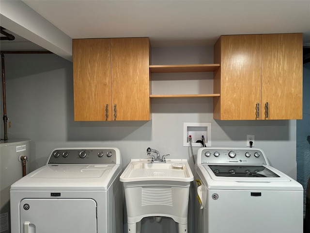 laundry room featuring washer and clothes dryer, water heater, cabinet space, and a sink