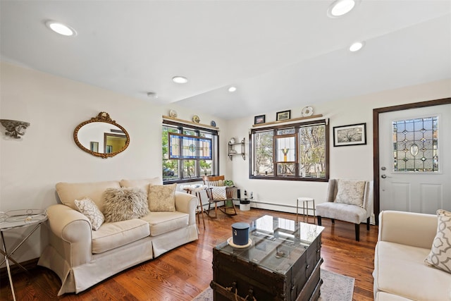 living area featuring a baseboard heating unit, recessed lighting, wood finished floors, and baseboards