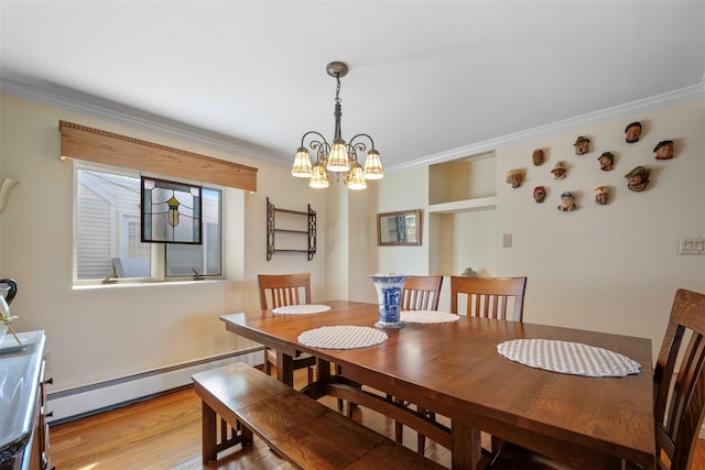 dining space with a notable chandelier, light wood finished floors, crown molding, and a baseboard radiator