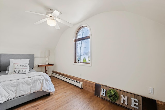 bedroom with lofted ceiling, ceiling fan, baseboard heating, and wood-type flooring