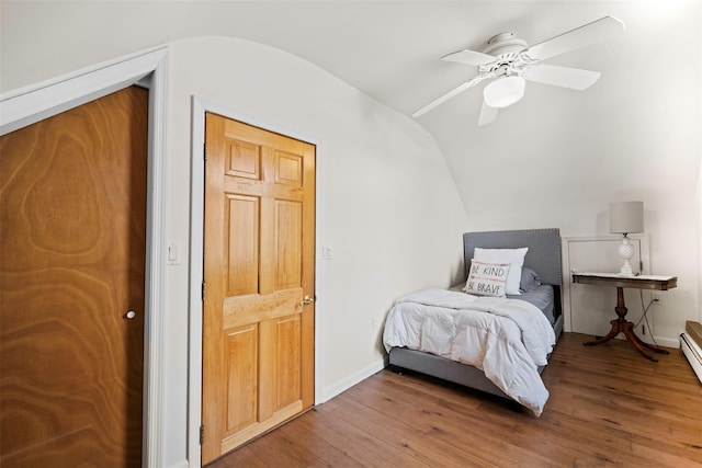 bedroom with baseboards, hardwood / wood-style flooring, a ceiling fan, and lofted ceiling