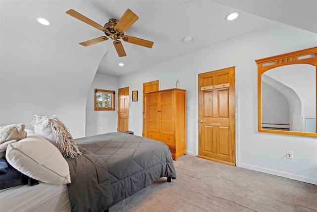 carpeted bedroom with recessed lighting, baseboard heating, and baseboards